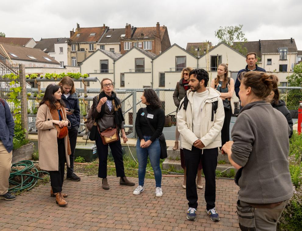 A climate walk stopped at the Refresh rooftop garden to learn about the why and how of this local garden project, Brussels, 8 May 2024.